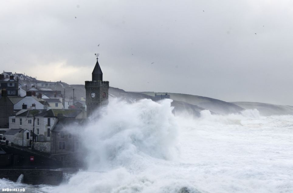 Dramatic: The church at Porthleven in south-west Cornwall is engulfed by waves during the high winds again battering the country