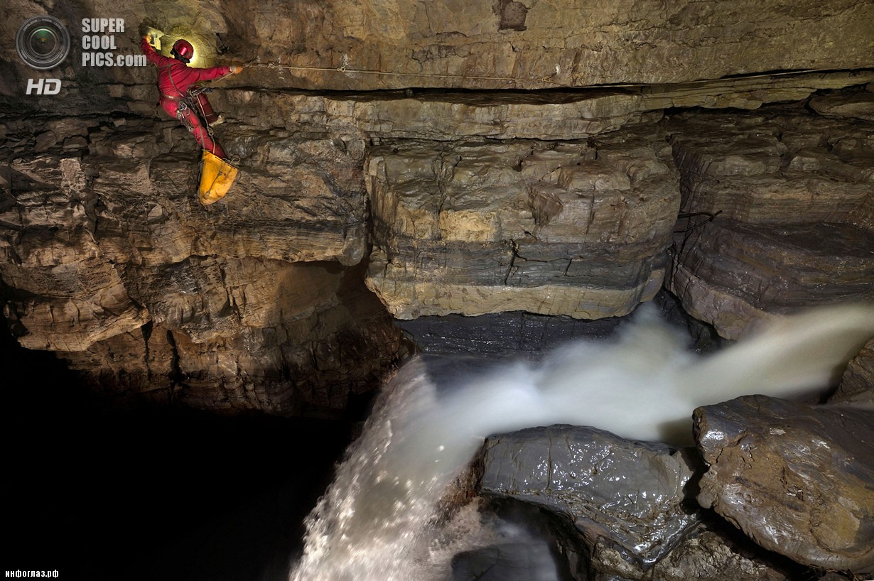 Китай. Улун, Чунцин. Эрин Линч взбирается по своду пещеры над подземным водопадом. (Robbie Shone/Caters News/ImagineChina)